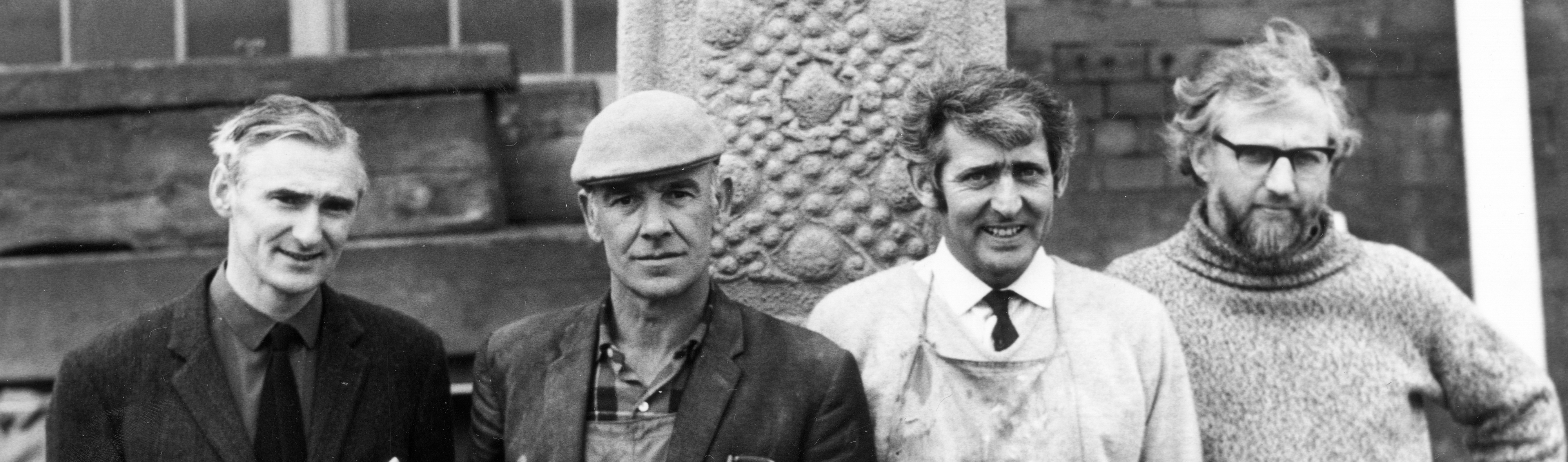 Detail of proud engineer, artists and craftsmen standing by recently made concrete replica of St John's Cross, Iona. Photographer Arthur Macgregor, (c) courtesy of Historic Environment Scotland (J R Scott Collection)